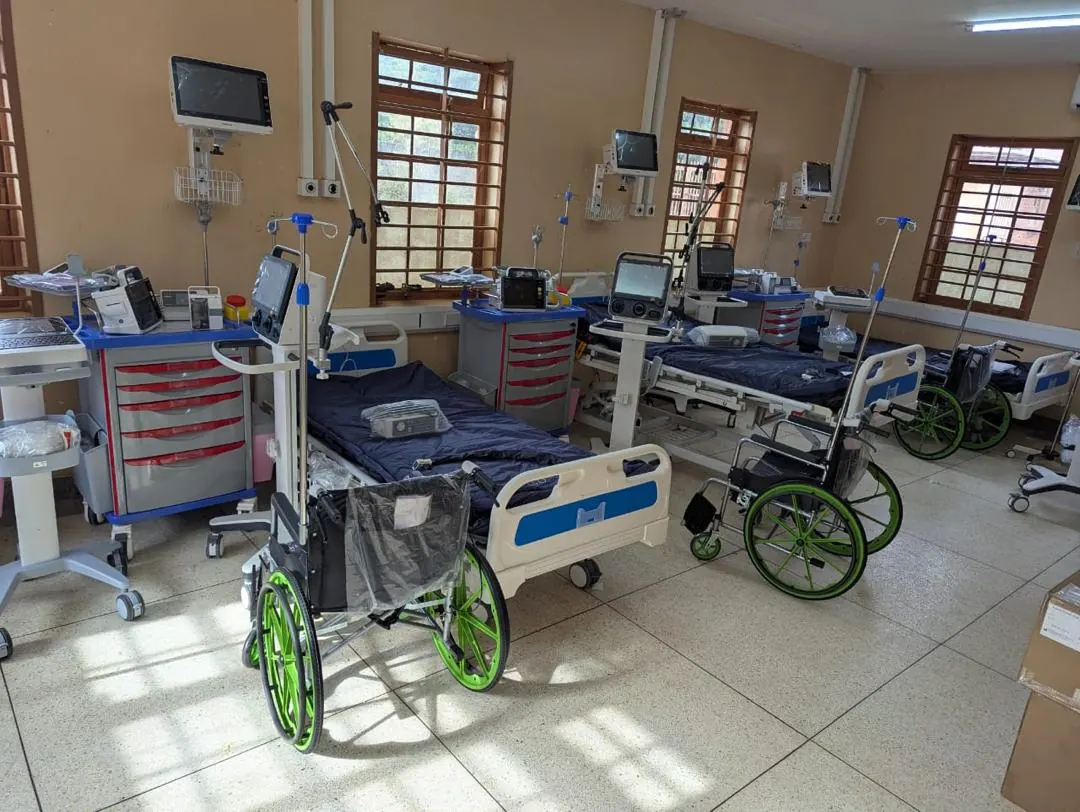 Hospital ward equipment setup with beds, monitors, wheelchairs, and clinical carts