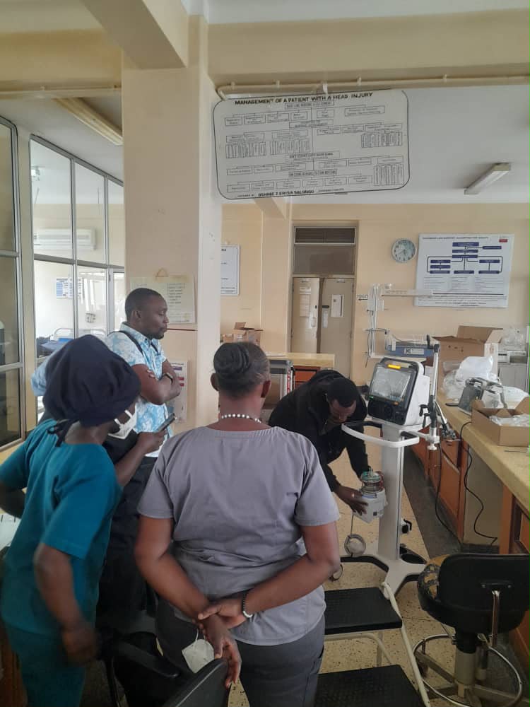 Clinical staff receiving hands-on medical equipment support and training